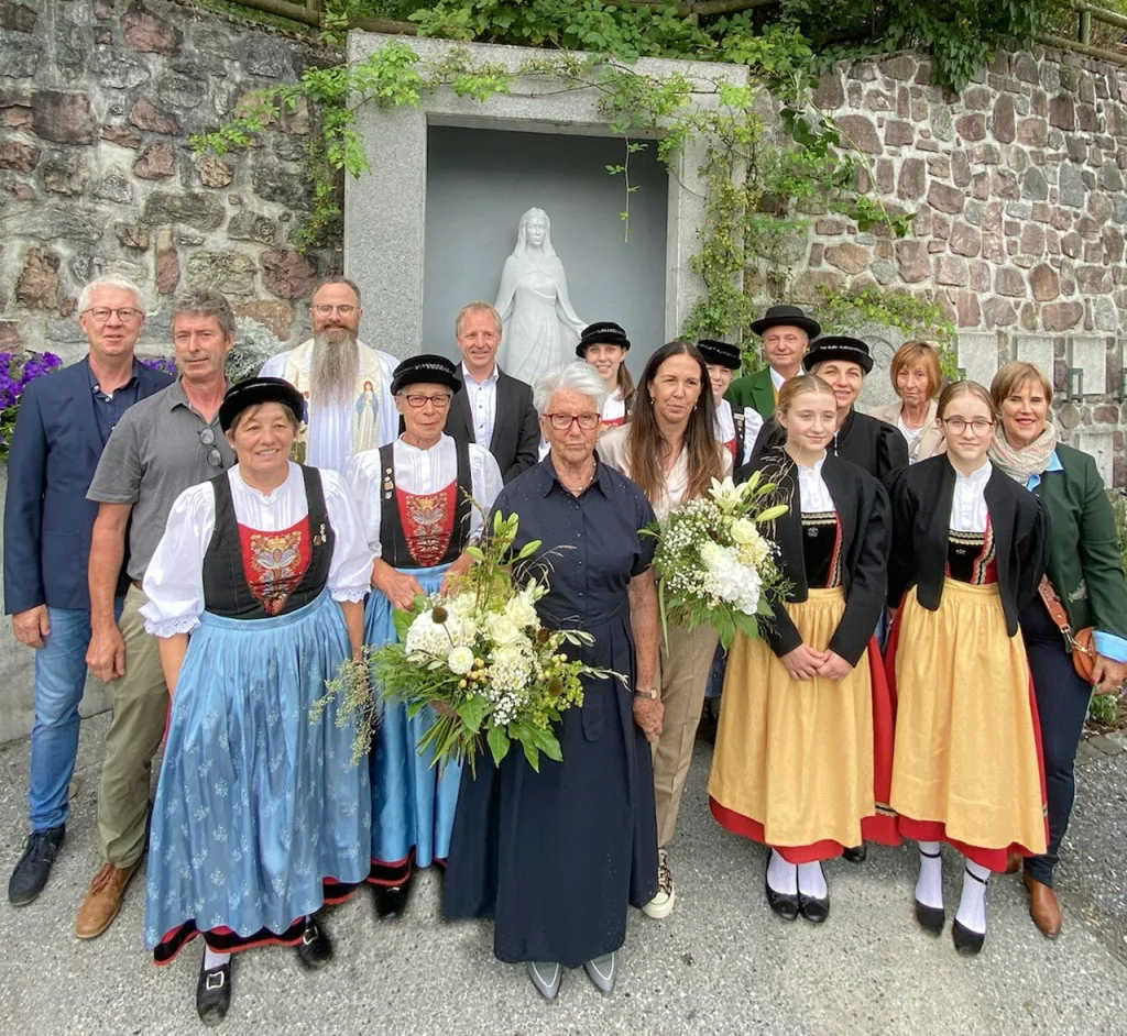 Vertreter der Friedhofskommission, der Künstler Lucas Walt, Pfarrer Georg Hirsch, Vor-steher Christoph Beck, Ruth und Jacqueline Vogt der Hand in Hand Anstalt sowie Vertre-terinnen der Triesenberger Trachten